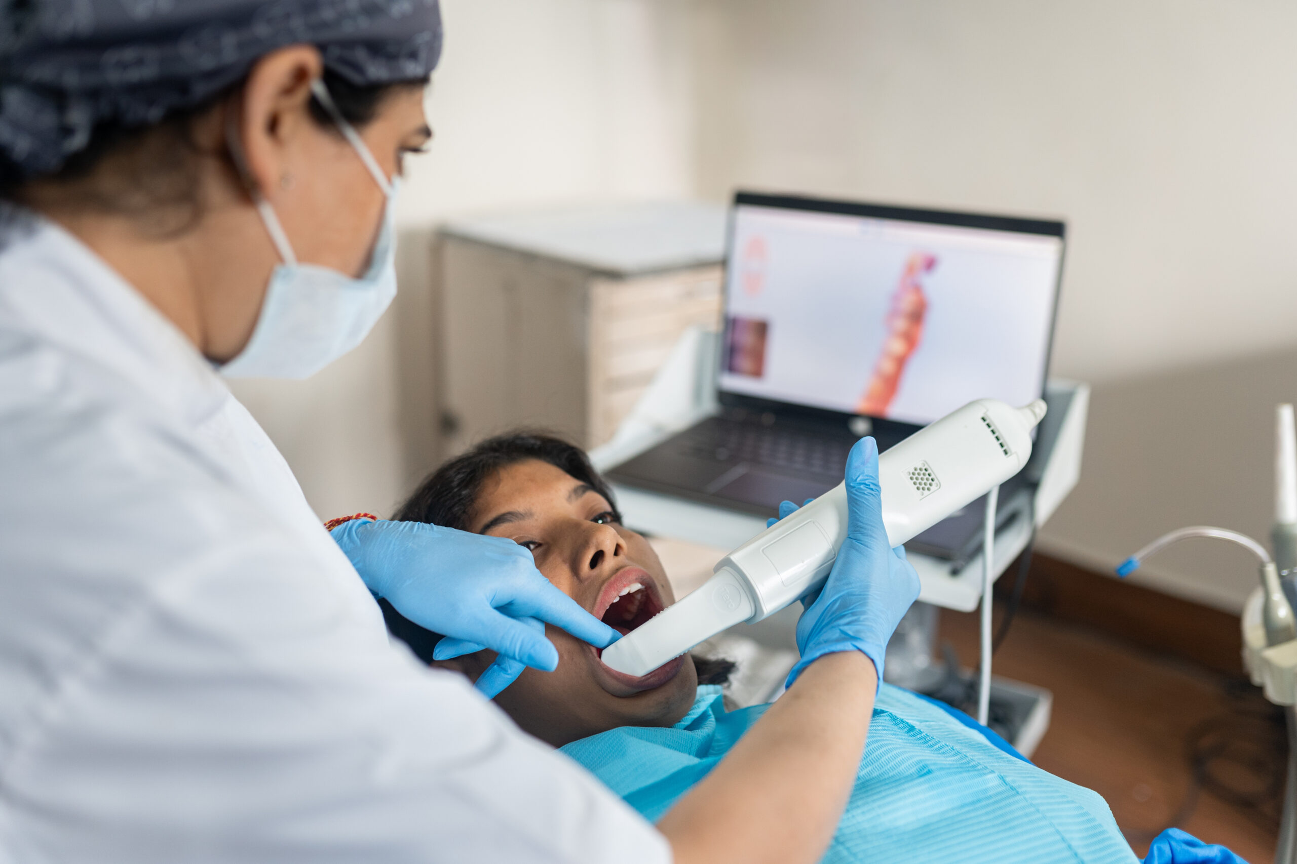 Dentist Using an Intraoral Scanner for a 3D Model of the Mouth at dental clinic