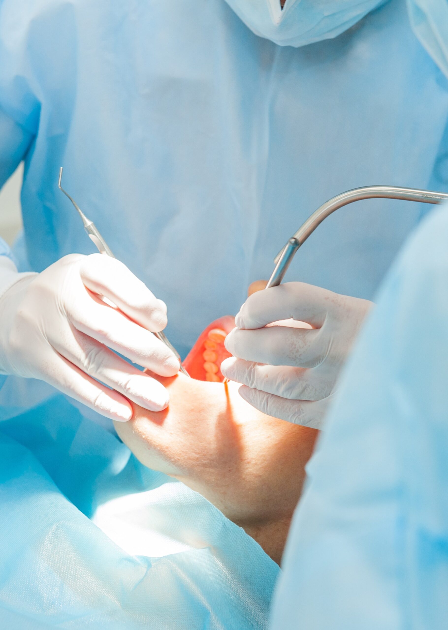 Close up dental surgery process - Implantation. Dentist surgeon with assistant in modern clinic. Stomatology and health care concept. selective focus. Space for text