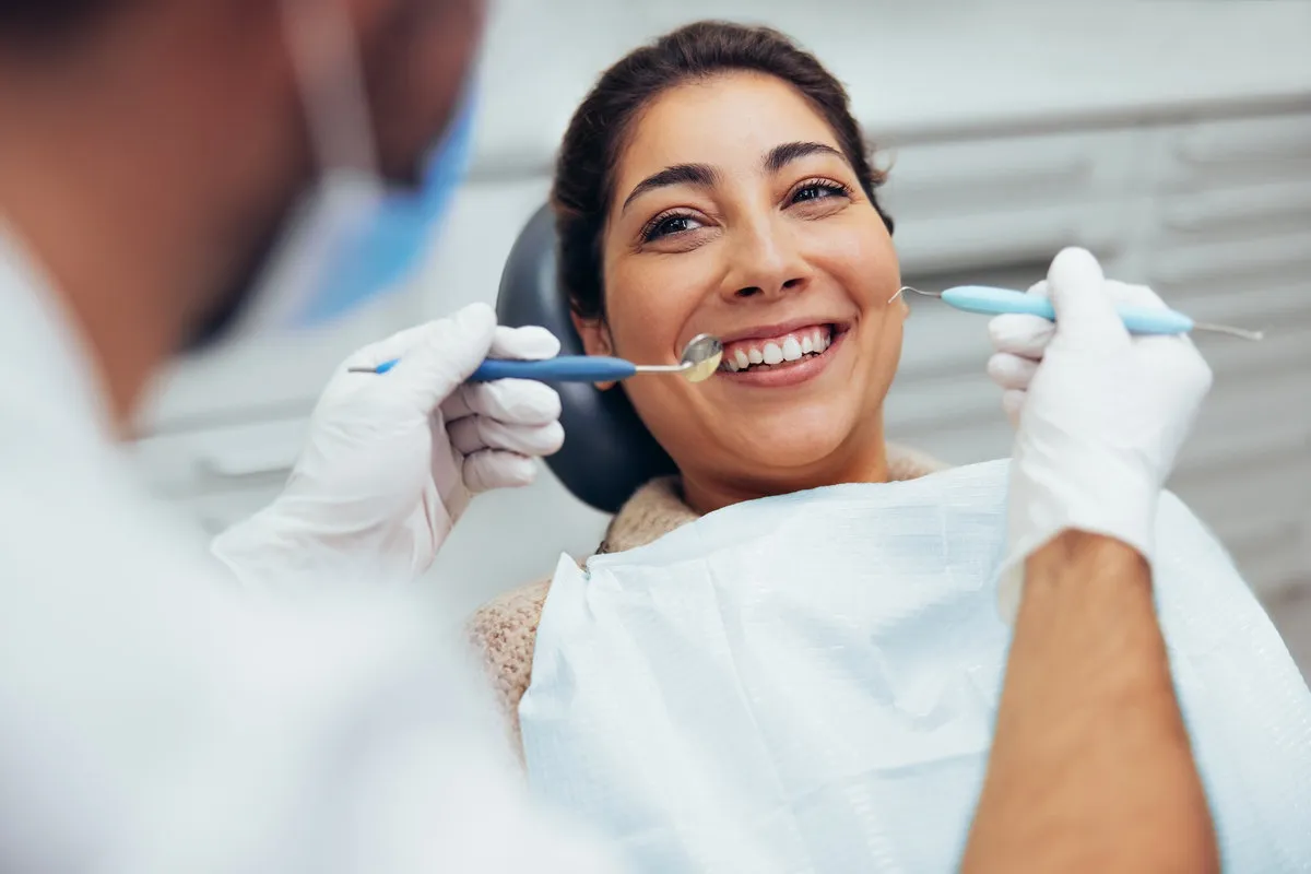 Woman having teeth examined at dentist