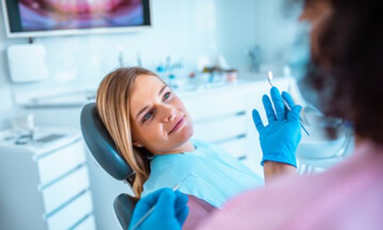 Dentist and patient during a preventive dental cleaning appointment
